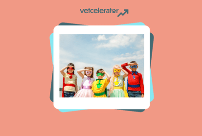 Group of five children dressed in colorful superhero capes and masks under a clear blue sky.