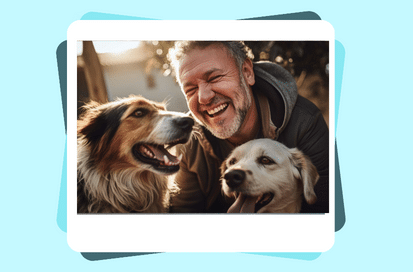 Man smiling with two dogs, one golden and one collie, in a joyful scene.
